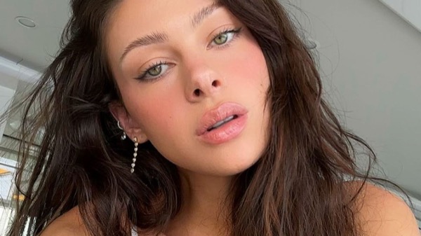 Woman holding collagen supplement for skin and wellness