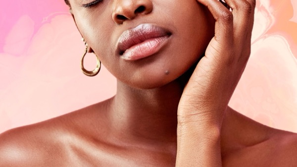 Woman with healthy glowing skin examining collagen supplement